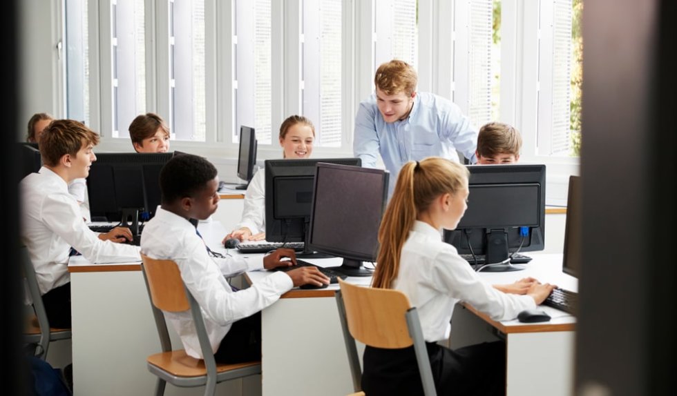 Students in computer lab with teacher.