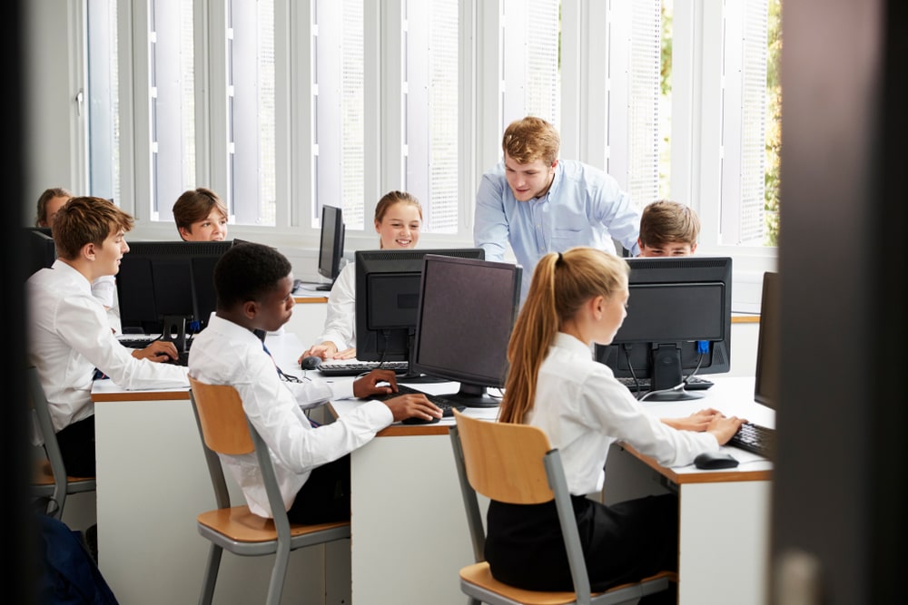 Students in computer lab with teacher.