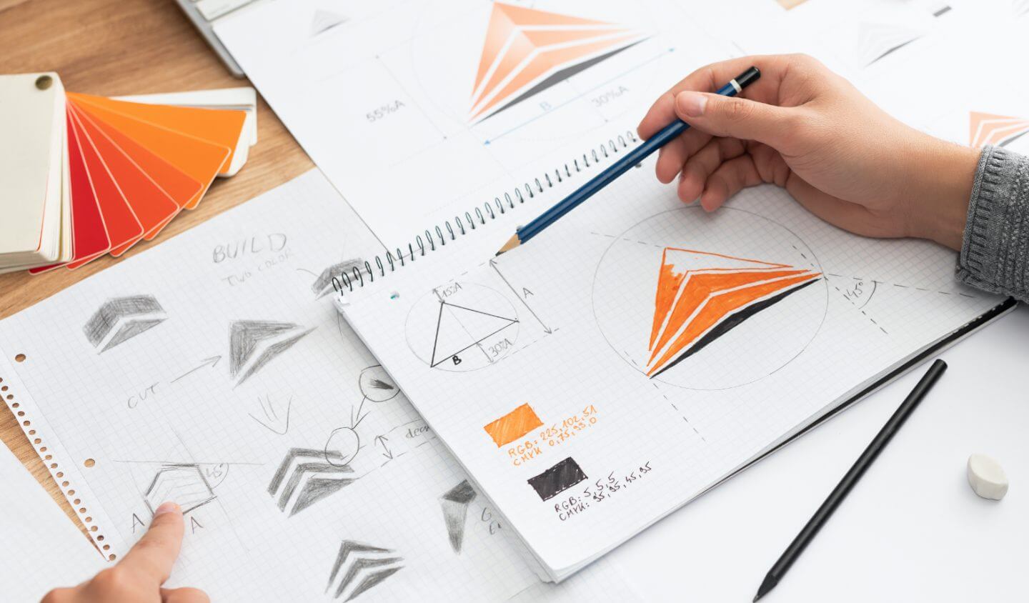 Graphic designer sketches logo.