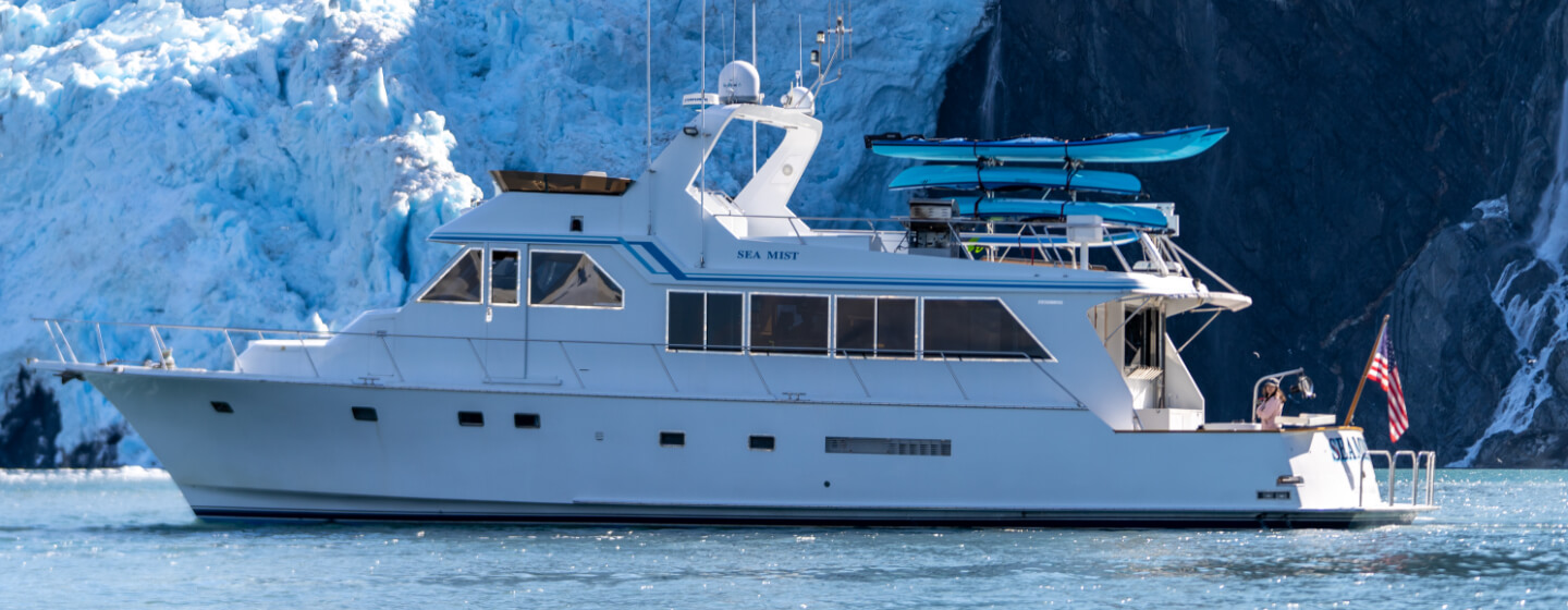 Alaska Luxury Cruise Ship in front of Alaskan glacier.