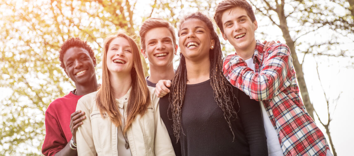 Group of young people laughing together.