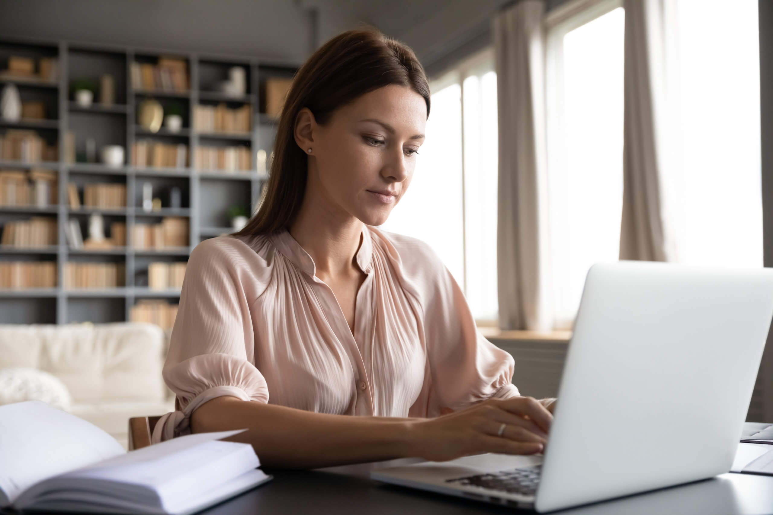 woman blogging, typing on laptop