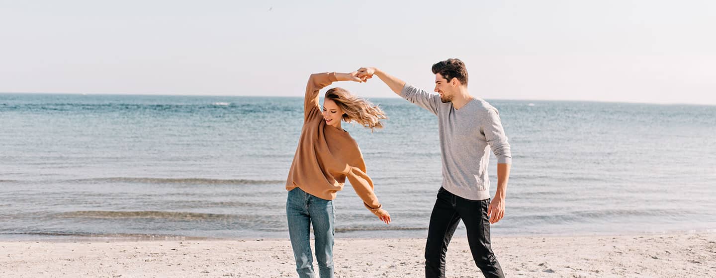 A couple dances on the beach, their mental health improved by services from NYC Therapeutic
