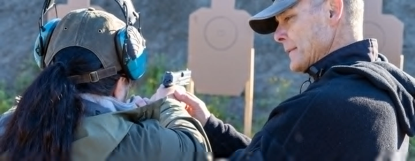 Alaska Tactical Owner Steve McDaniel helps student shoot firearm